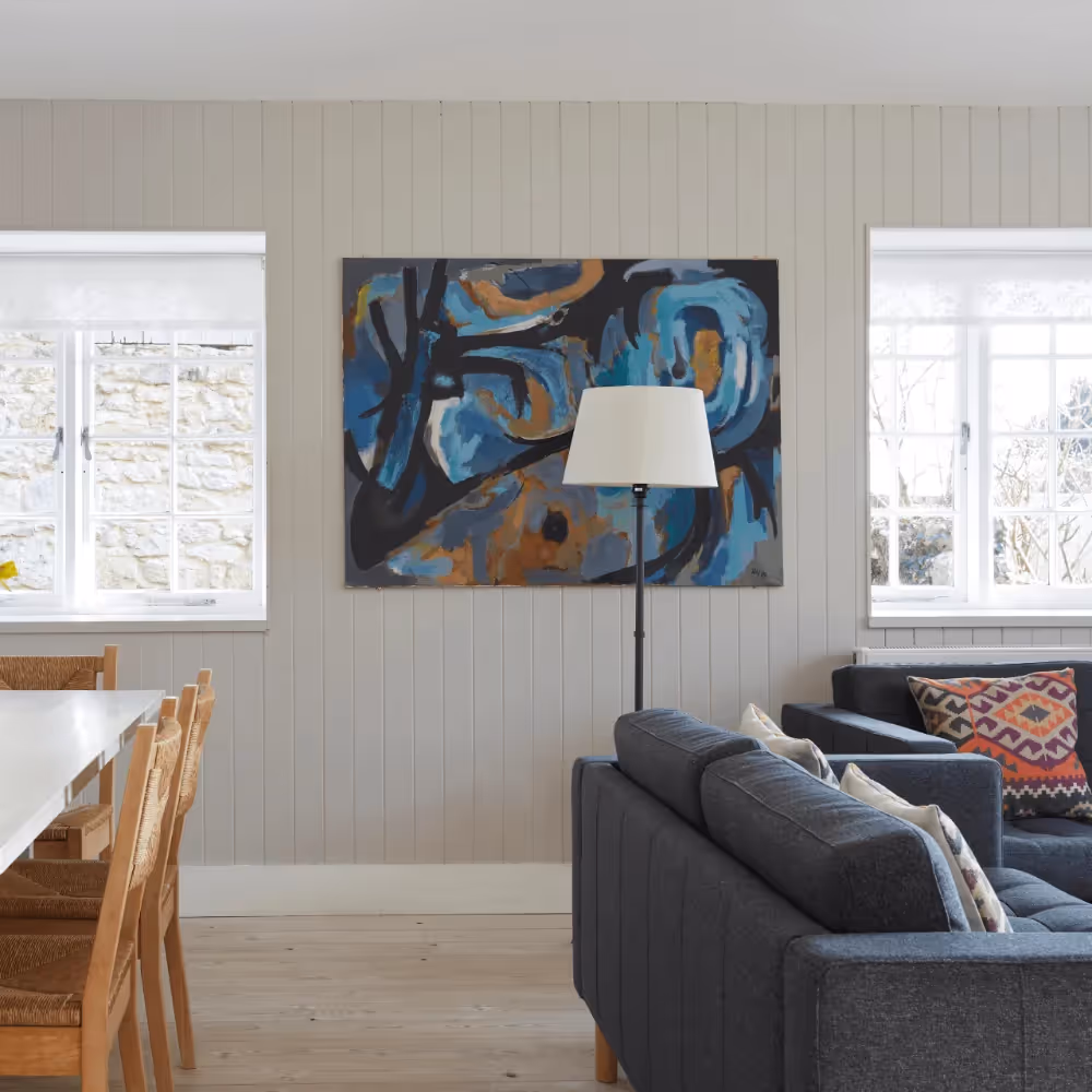 A living room with modern paintings and furniture