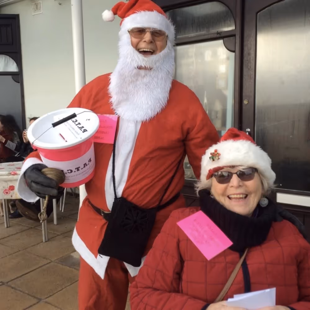 Two people in santa outfits