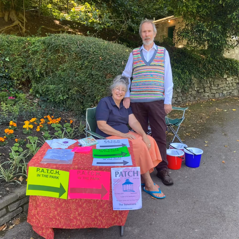 Two people running a charity stall