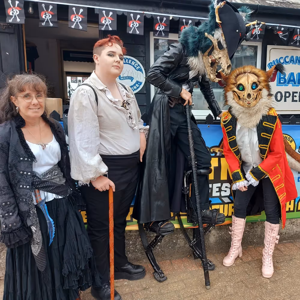 4 people wearing pirate costumes
