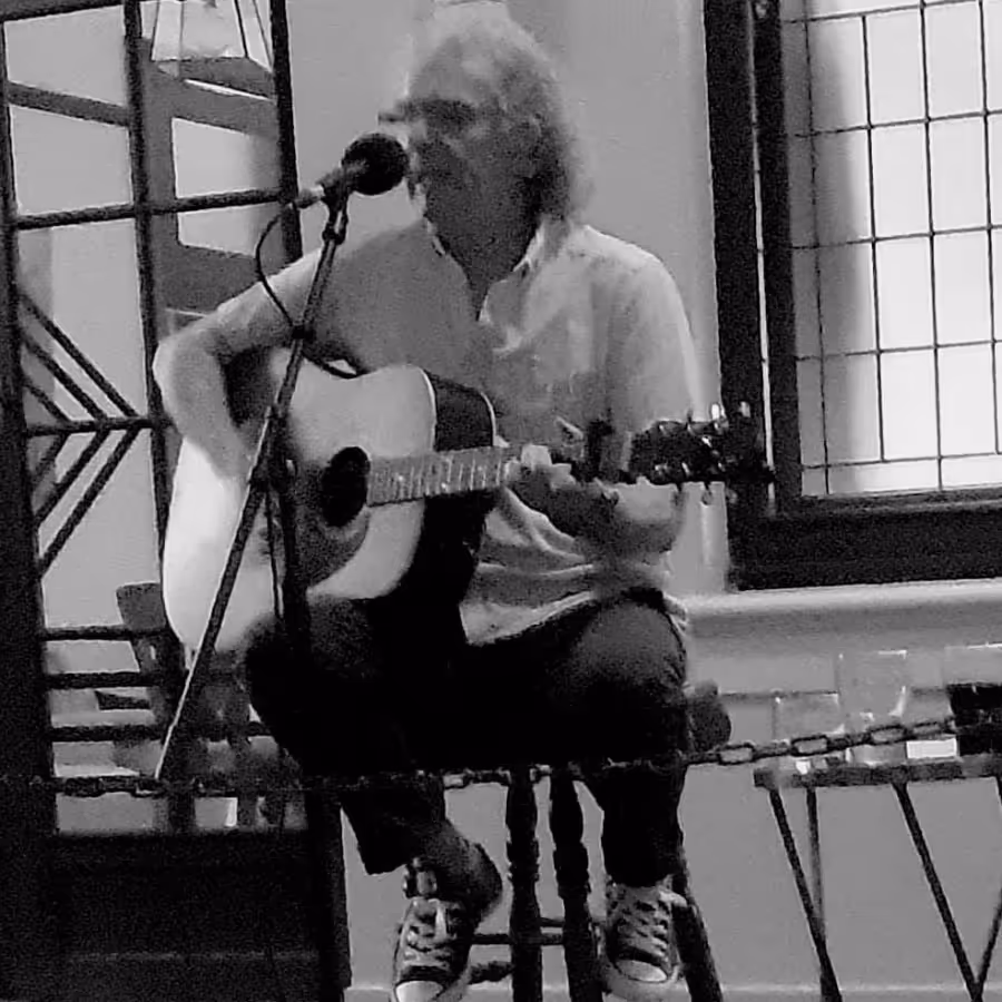 A man playing acoustic guitar