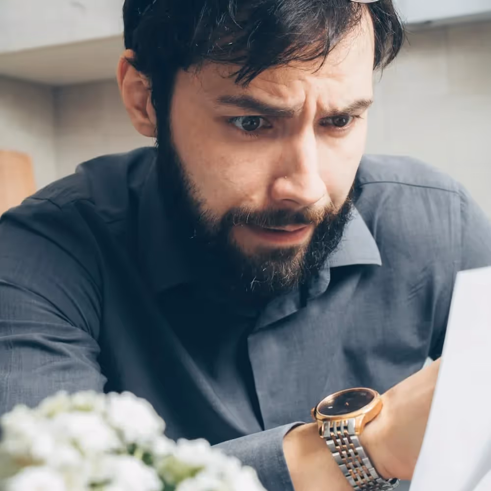 A worried man looking at his laptop