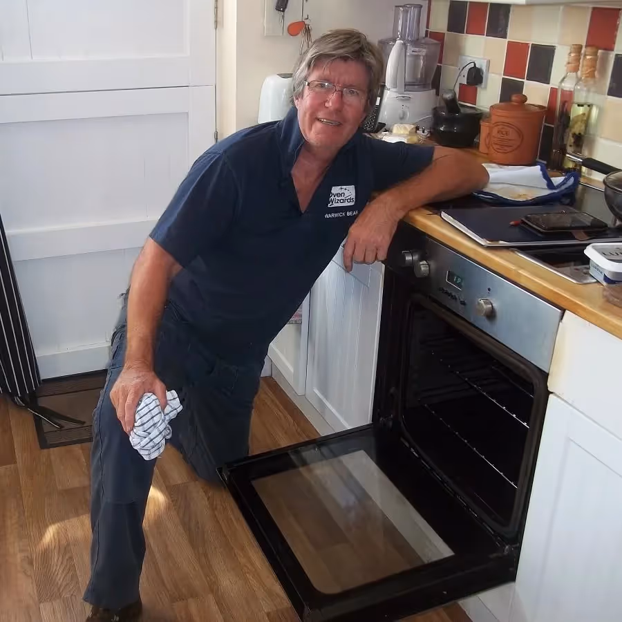 A man cleaning an oven