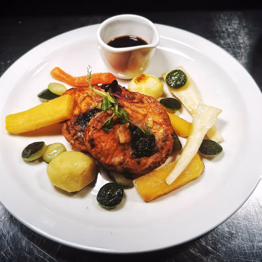 A chicken dish with tomato sauce and vegetables