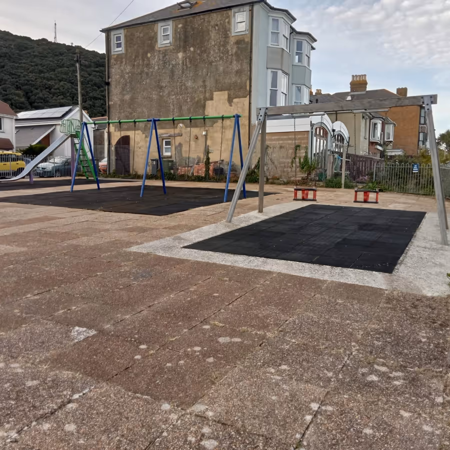 A kids play park with swings and slides