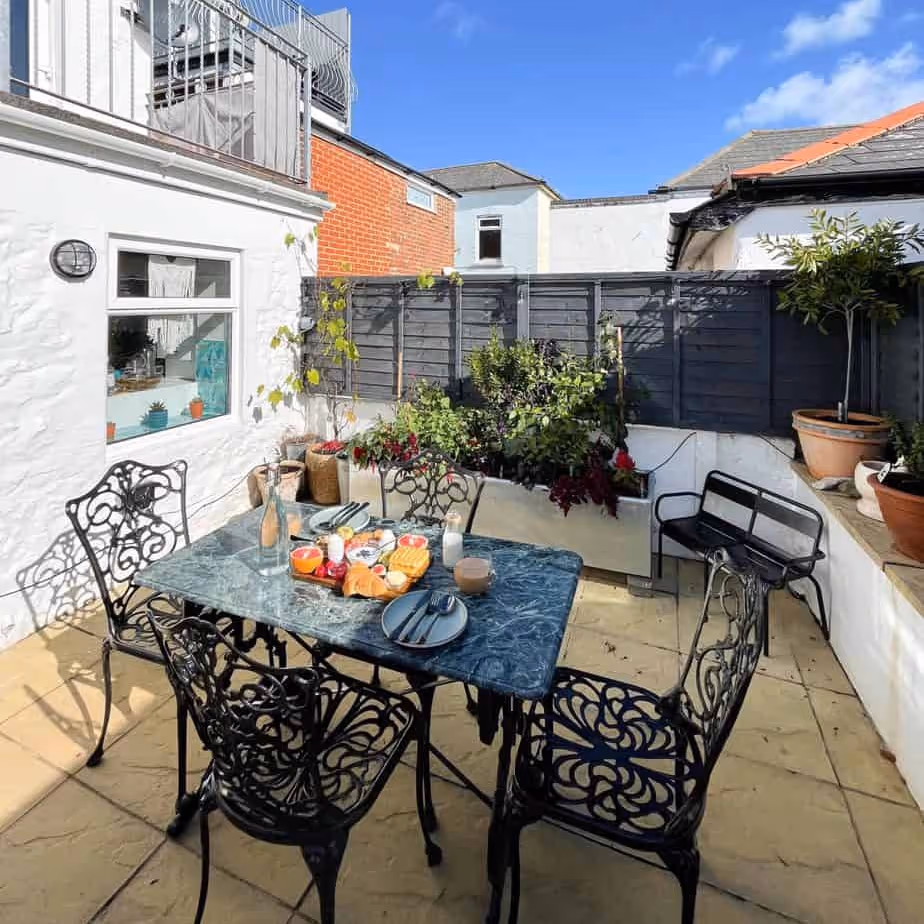 An outside courtyard with metal dining furniture