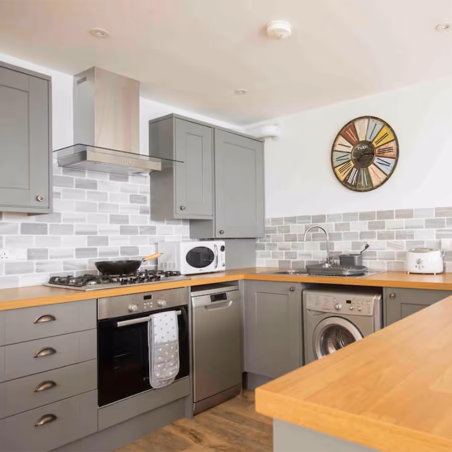 A grey shaker kitchen with beech worktops