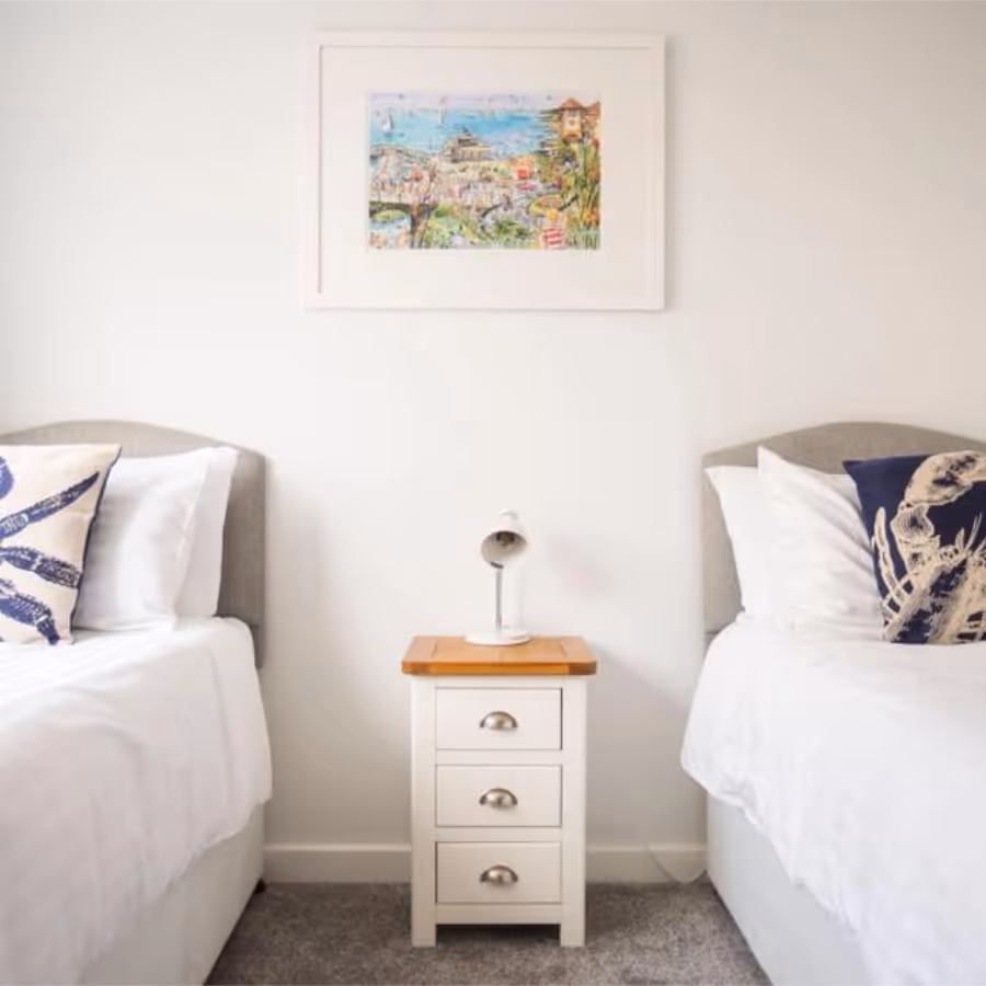 A white and blue twin bedroom