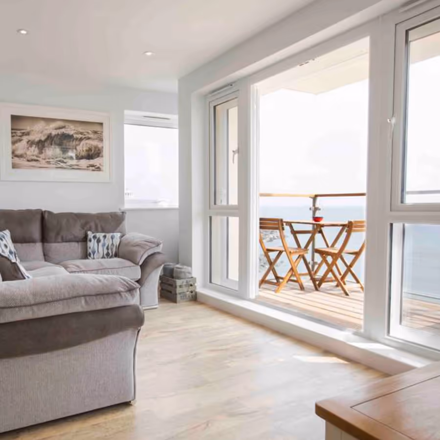 A bright living room with a seaview balcony