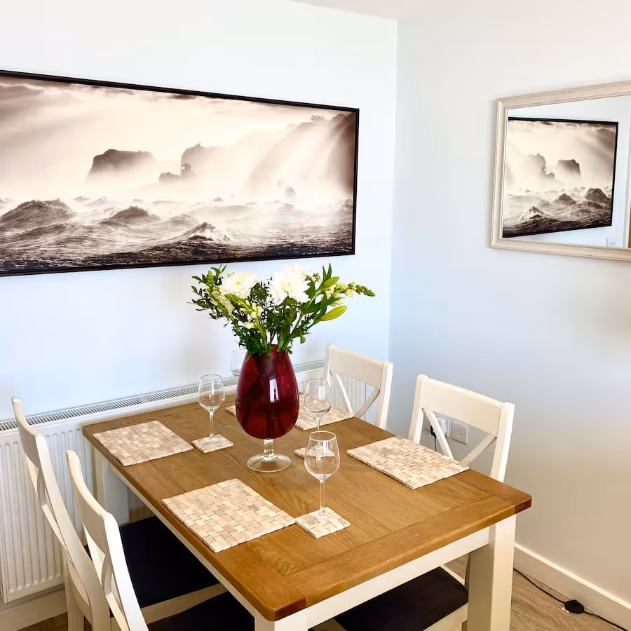 White and pine dining furniture in a coastal themed room
