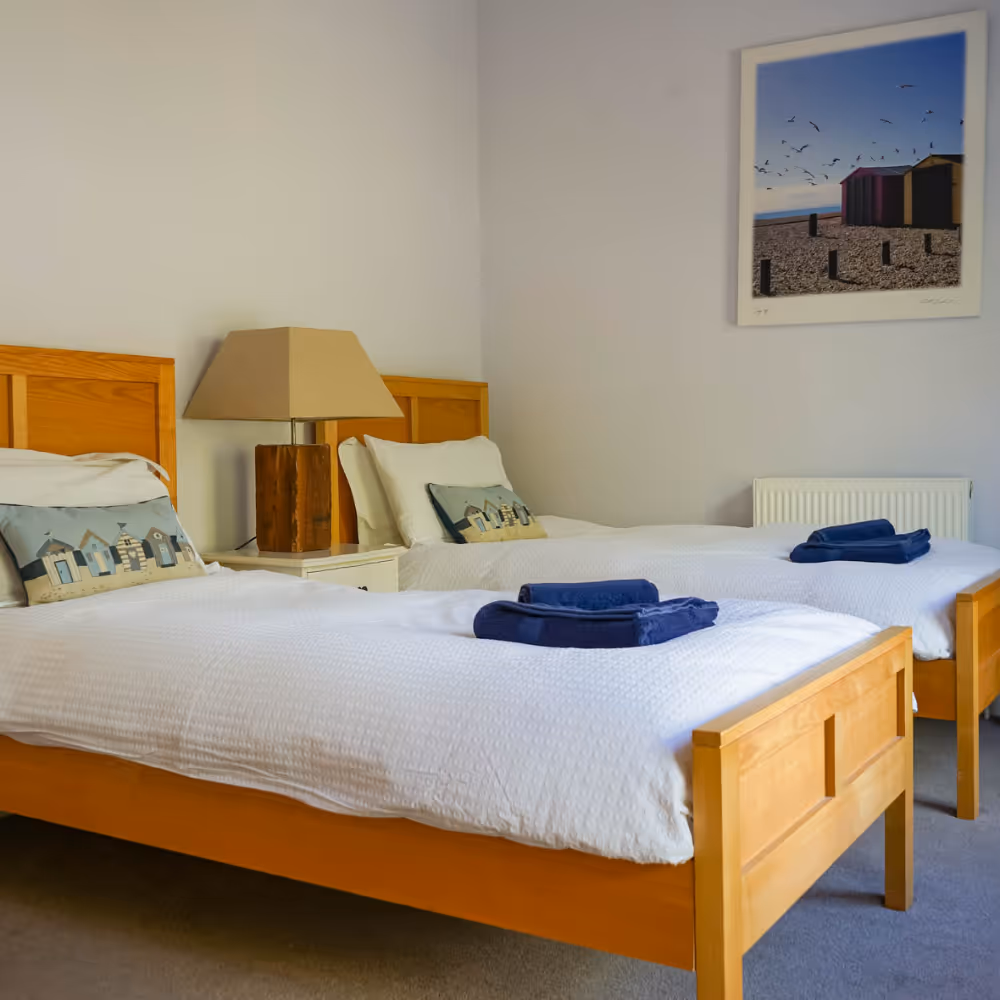 A twin bedroom with coastal decor