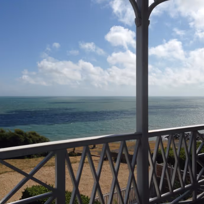 A balcony with a sea view