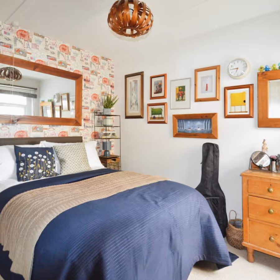 A bedroom with lots of pictures on the wall