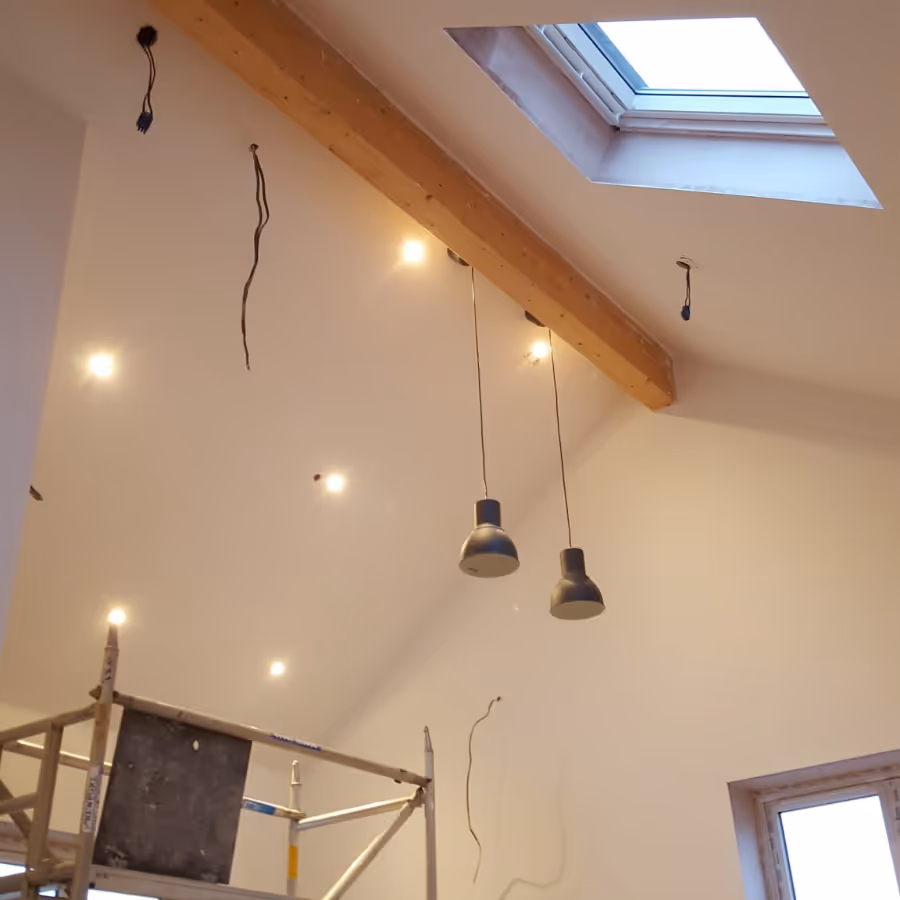 Lights being installed in a room with an apex ceiling