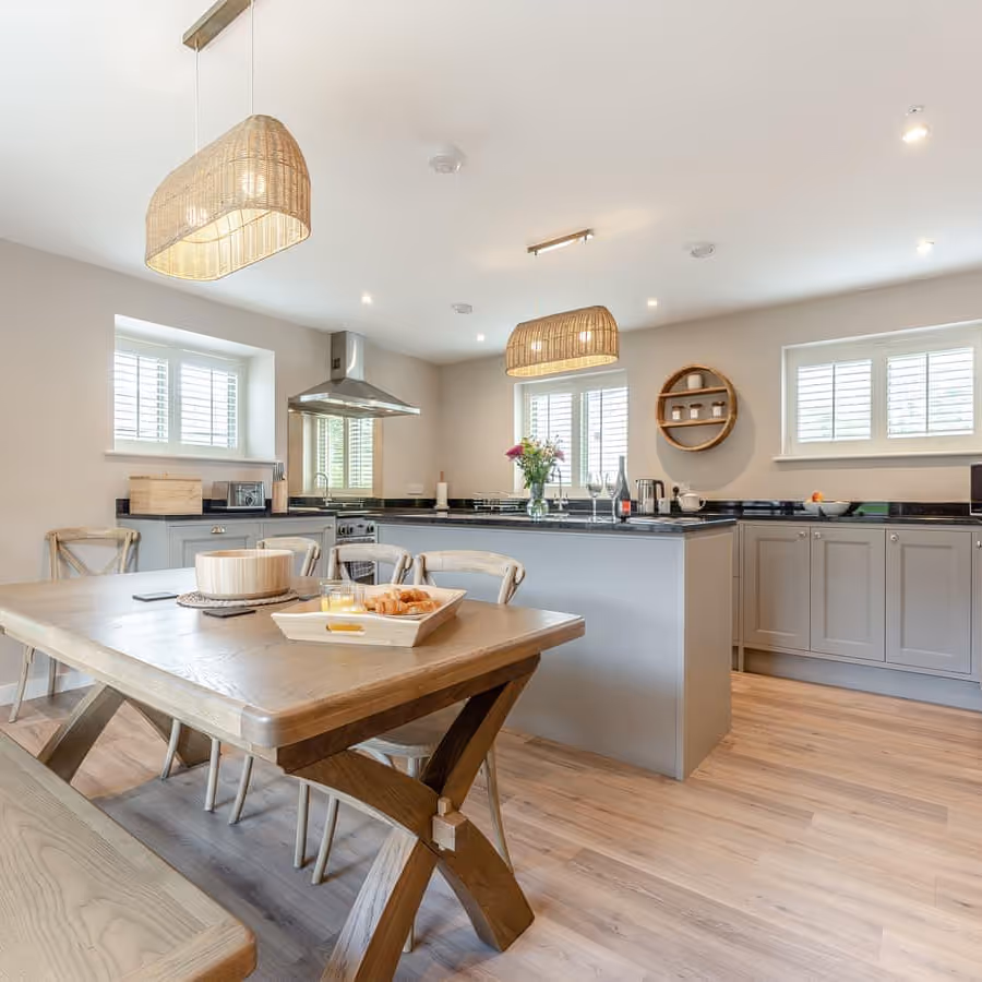 A grey shaker kitchen and oak dining table