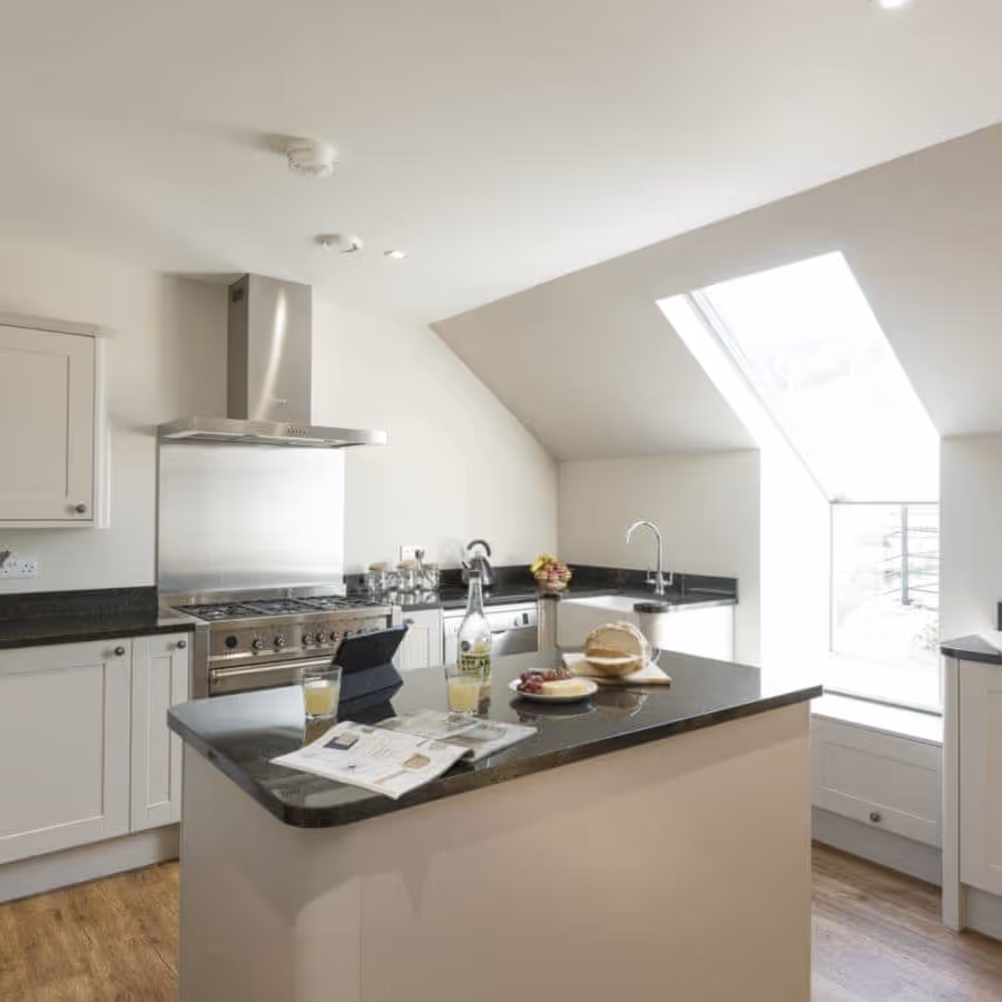A modern kitchen with white gloss units