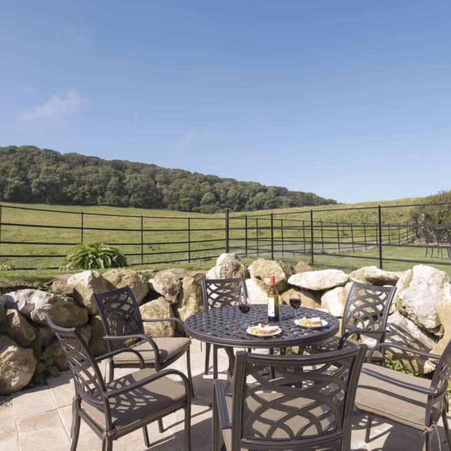 Garden dining furniture with a backdrop of fields