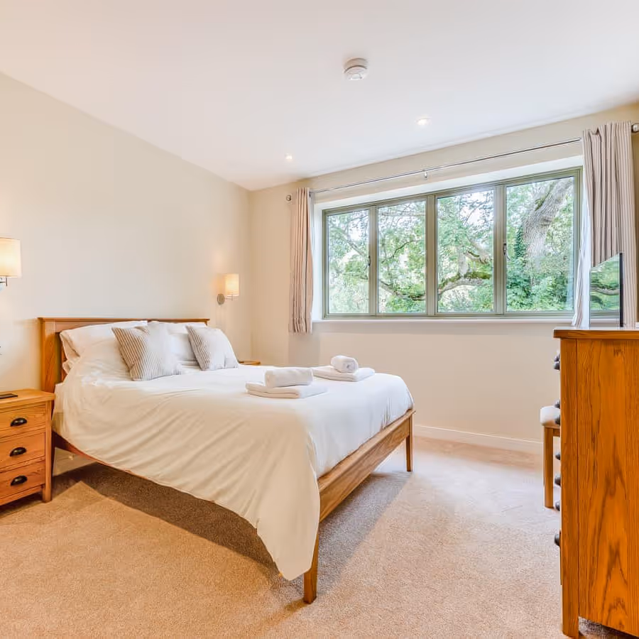 A large bedroom with oak furniture