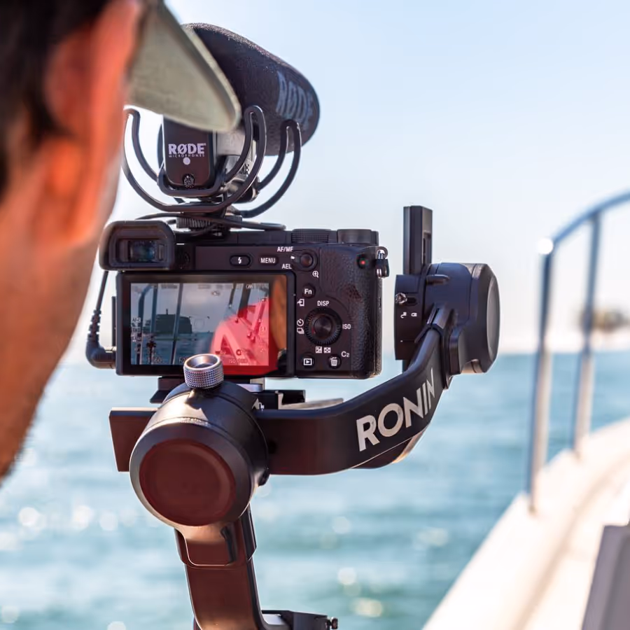 A professional photographer taking a photo on a sailing boat
