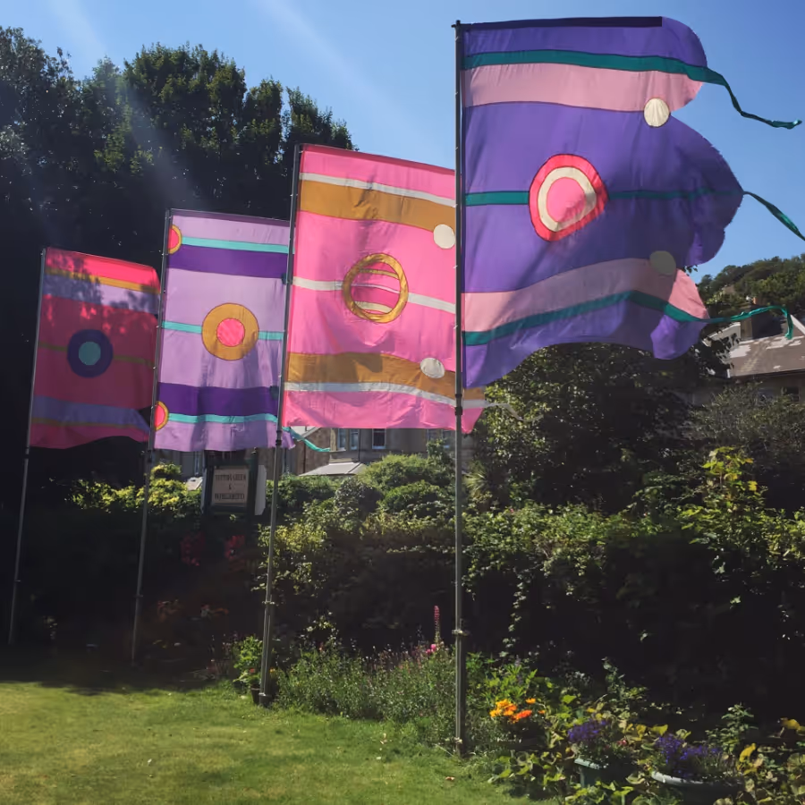 A row of large pink and purple festival flags