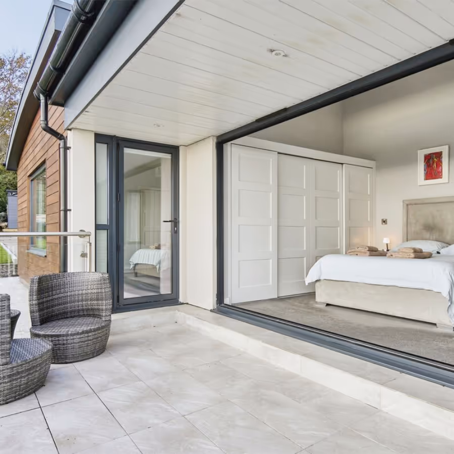 A bedroom with sliding doors accessing a terrace