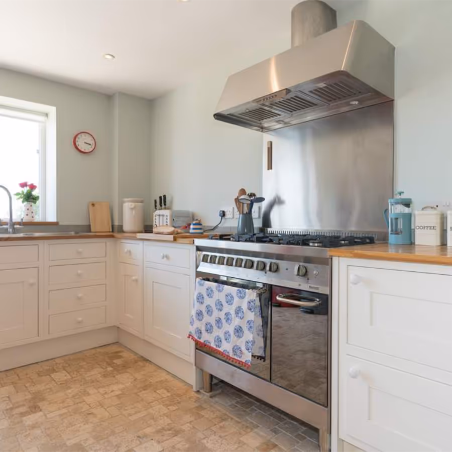 A cream shaker kitchen with beech worktops