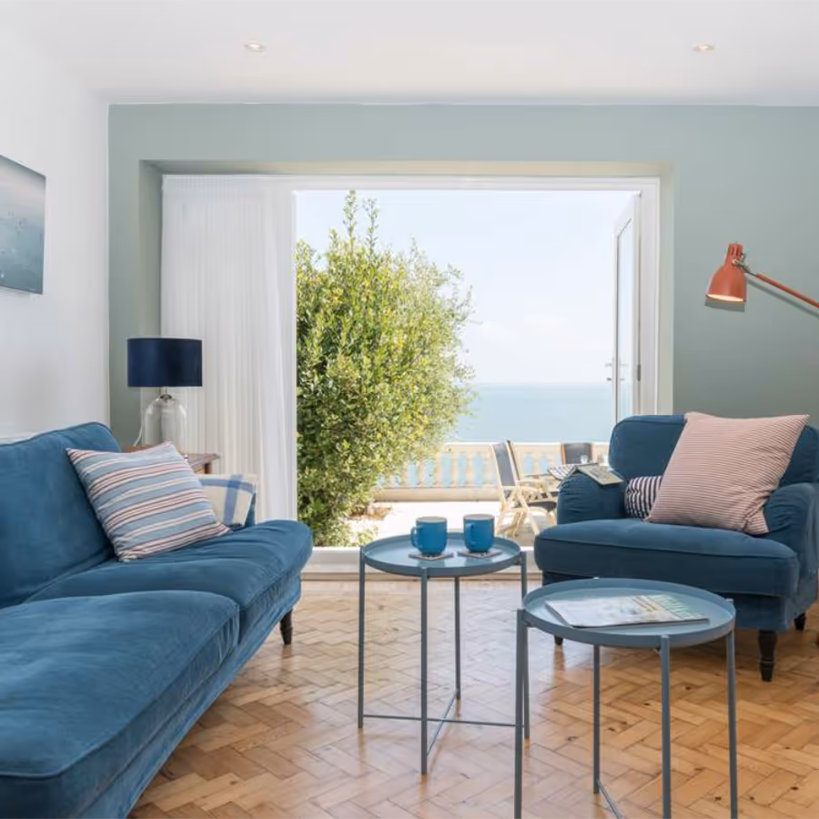 A restful sea green living room with teal sofas
