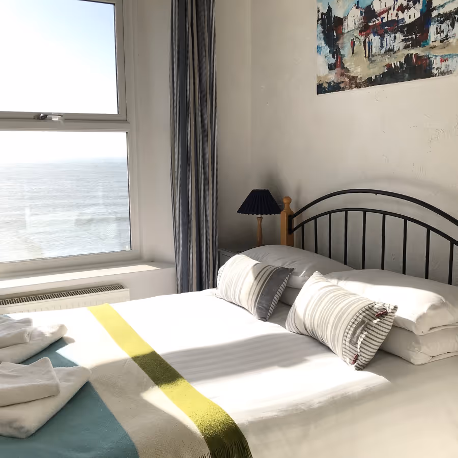 A bedroom with a view of the sea