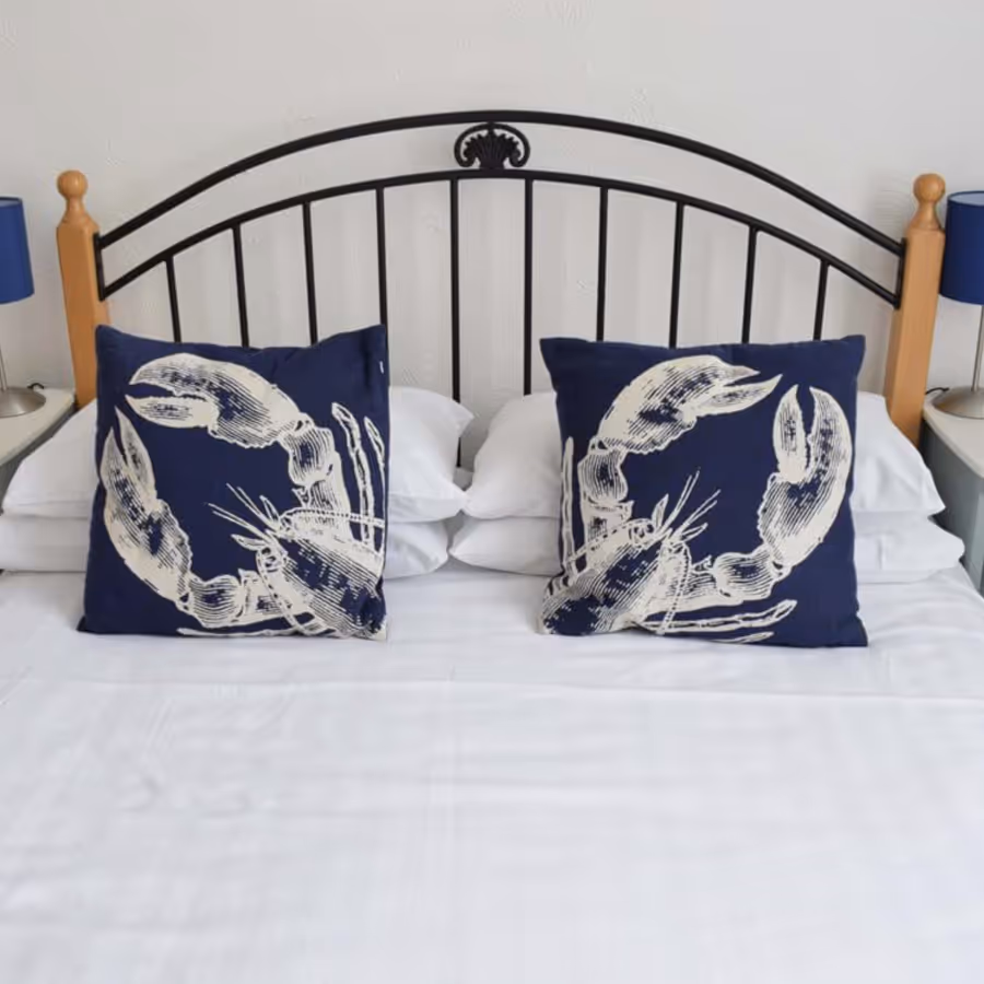 A black bedstead with blue and white bedding