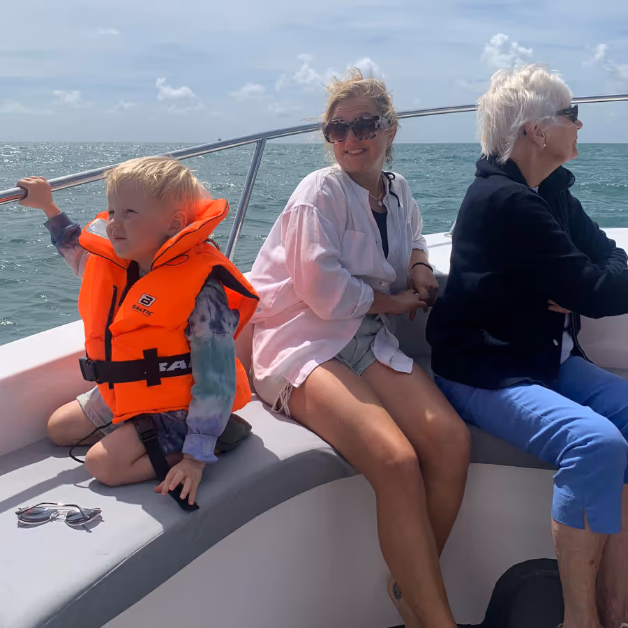 Two women and a child on a boat at sea