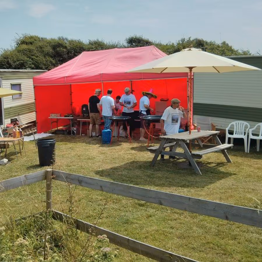 A paella cook off in a red gazebo
