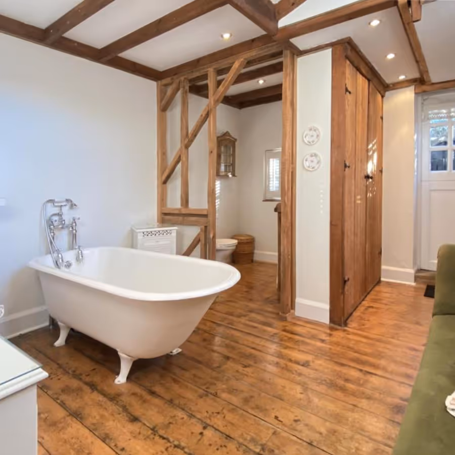 A country bathroom with roll top cast iron bath
