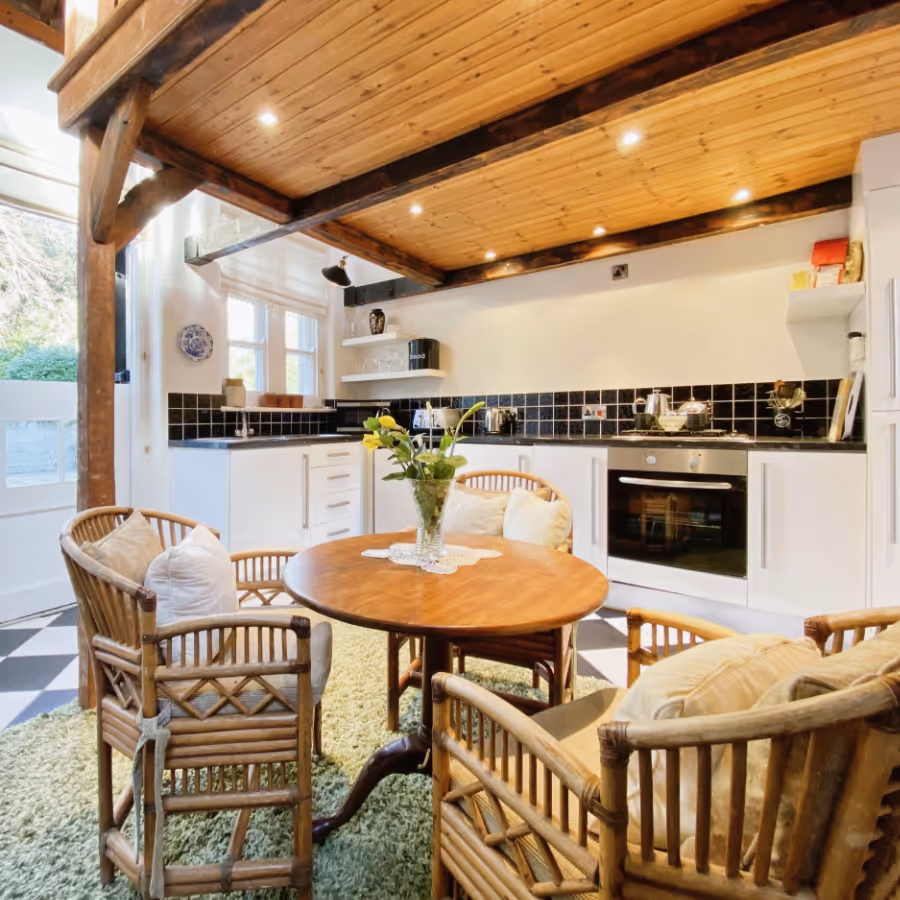A white kitchen with cane dining furniture