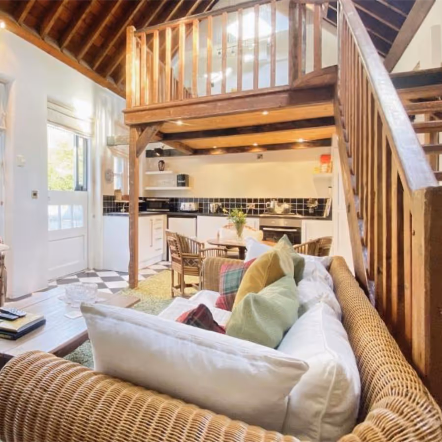 A living room with kitchen an mezzanine above