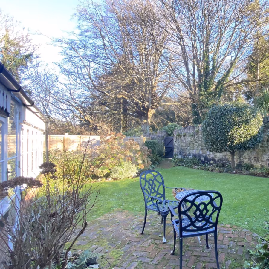 A garden with cast iron table and chairs