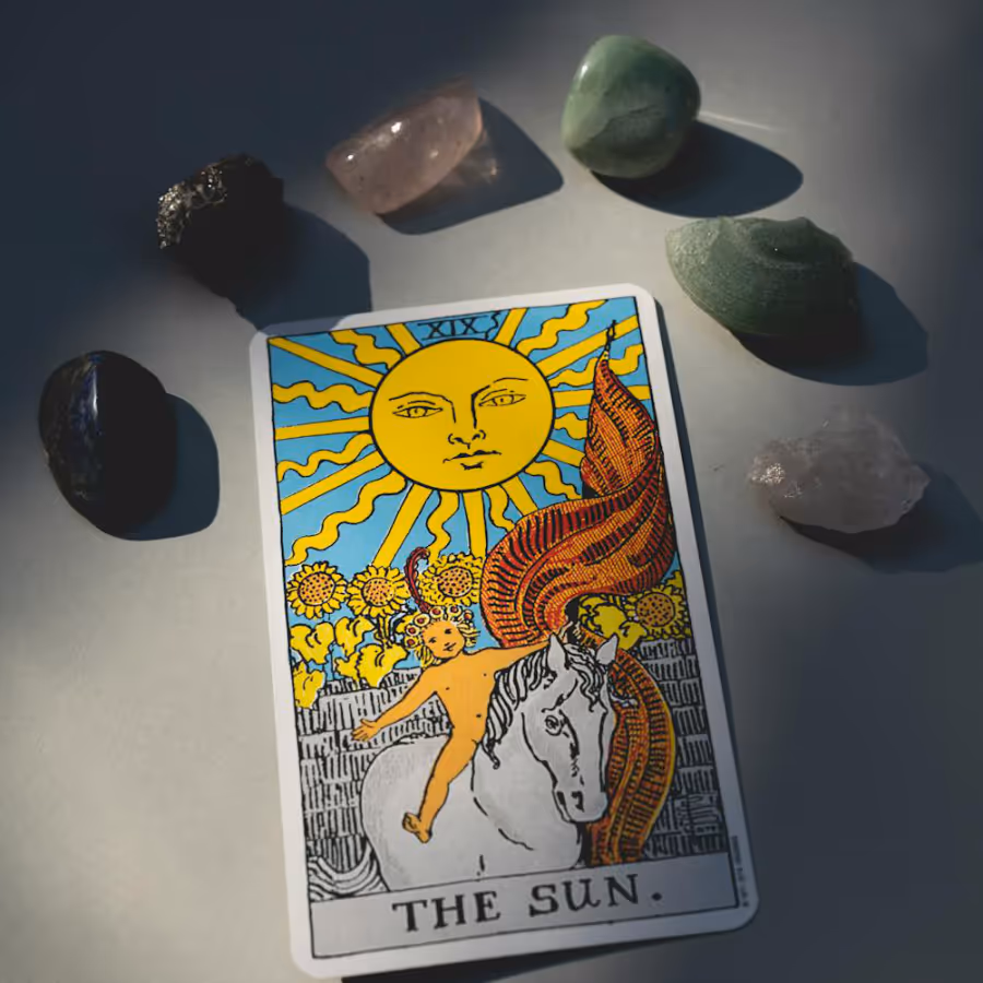 A tarot card and some healing crystals
