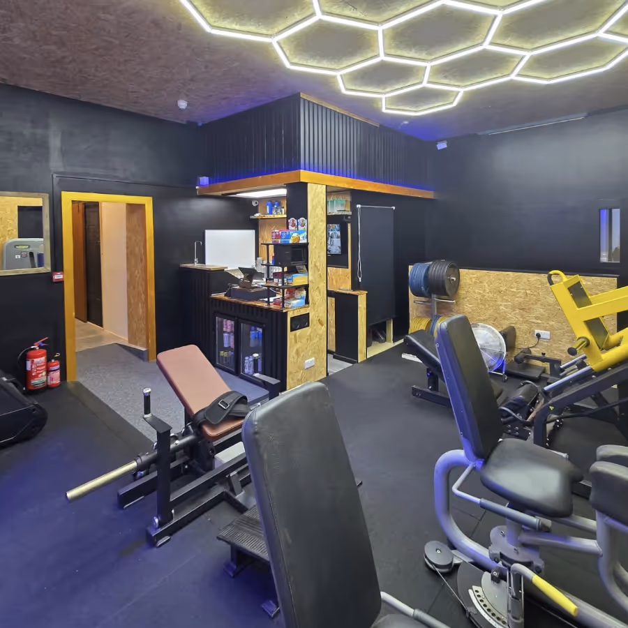 A fitness gym with a hexagonal LED ceiling light