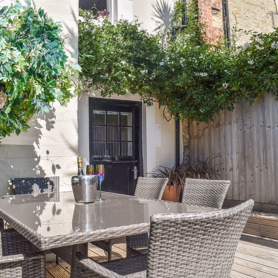 An outside courtyard with wicker dining furniture