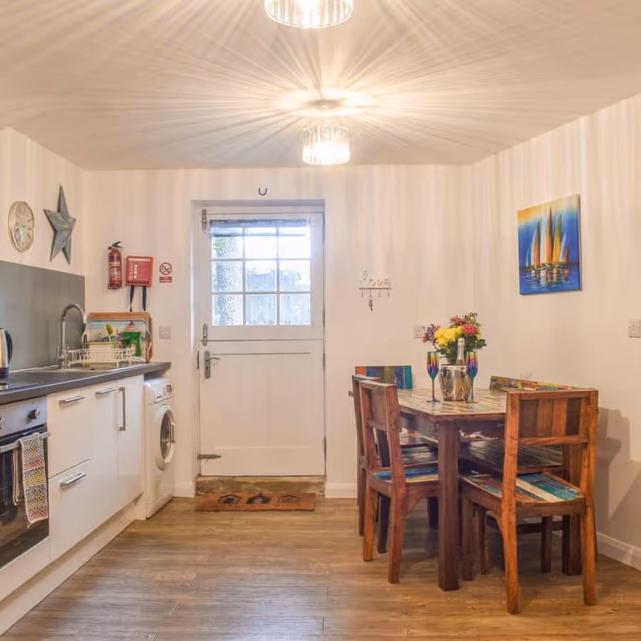 A white kitchen with pine dining furniture