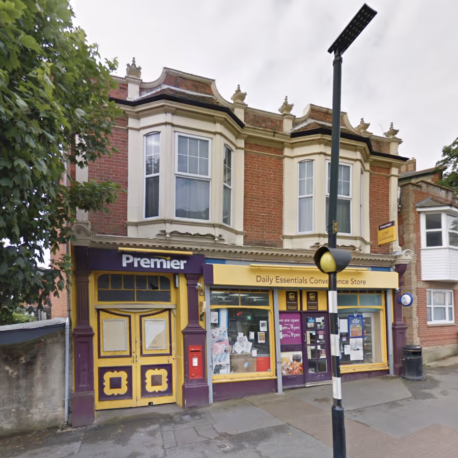 A convenience store in a period red brick building