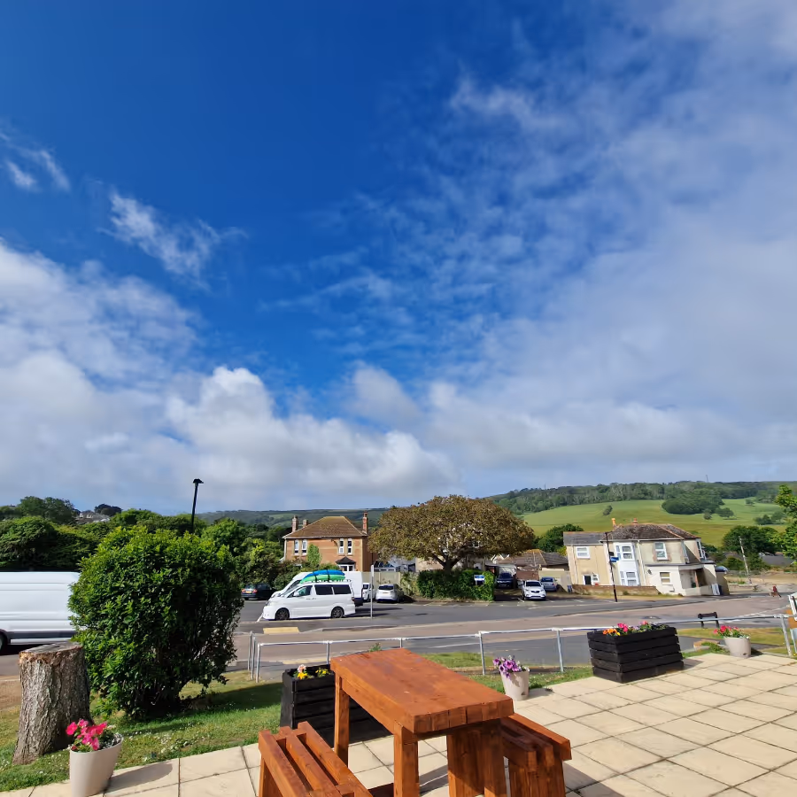 Picnic benches on a patio with a far reaching view