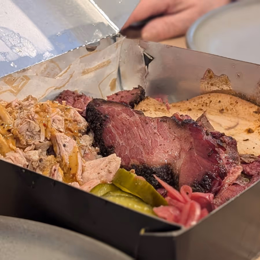 A takeaway box containing a selection of meat