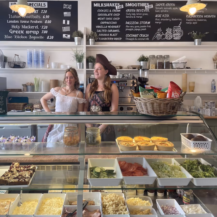 Two ladies behind the counter of a takeaway deli
