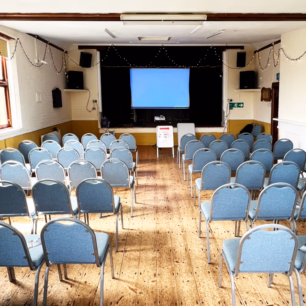 A village hall set up with chairs ready for a talk