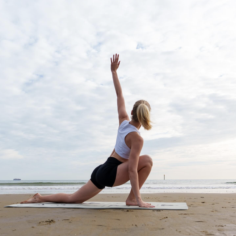 A lady doing pilates on a beach