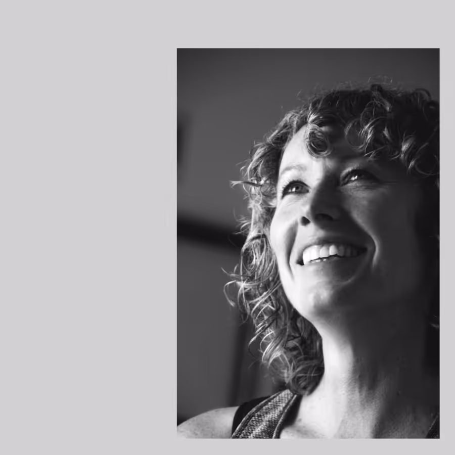 A black and white photo of a smiling woman