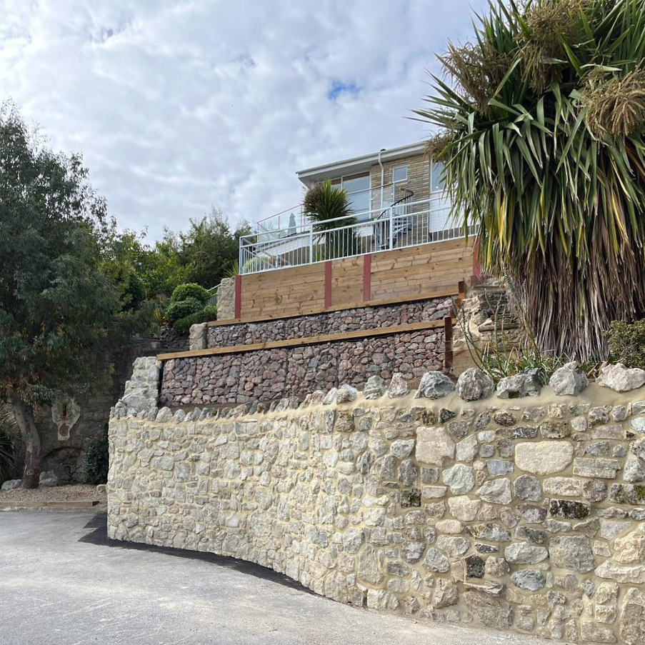 A house with gabions in a terraced garden