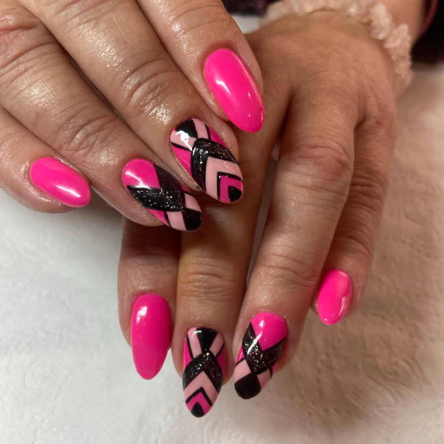 Newly manicured nails in bright pink and black
