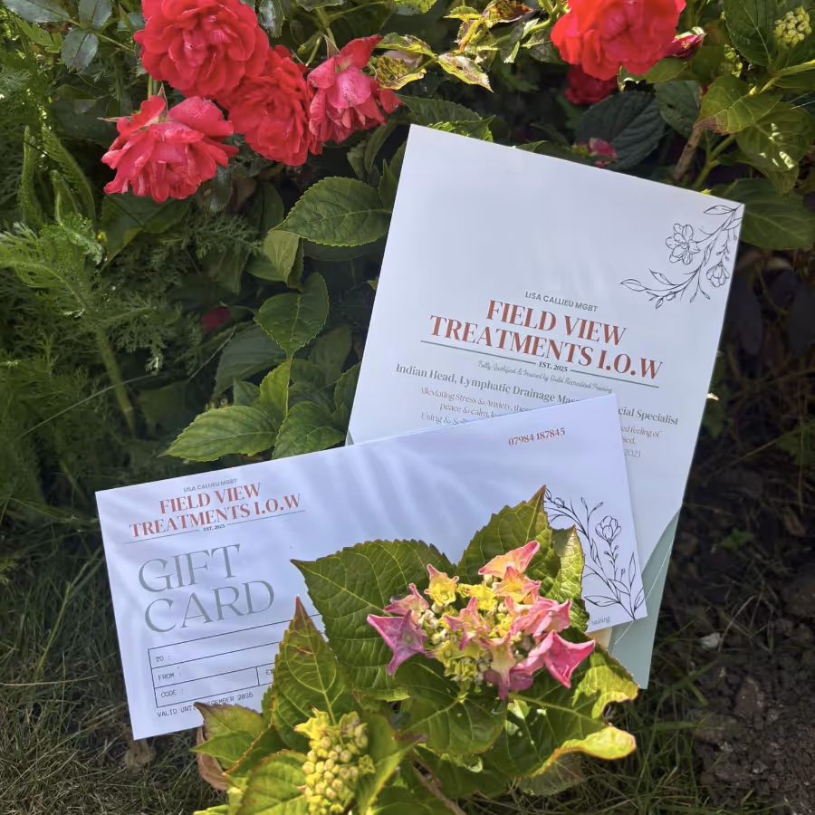 Two gift vouchers in front of some red roses