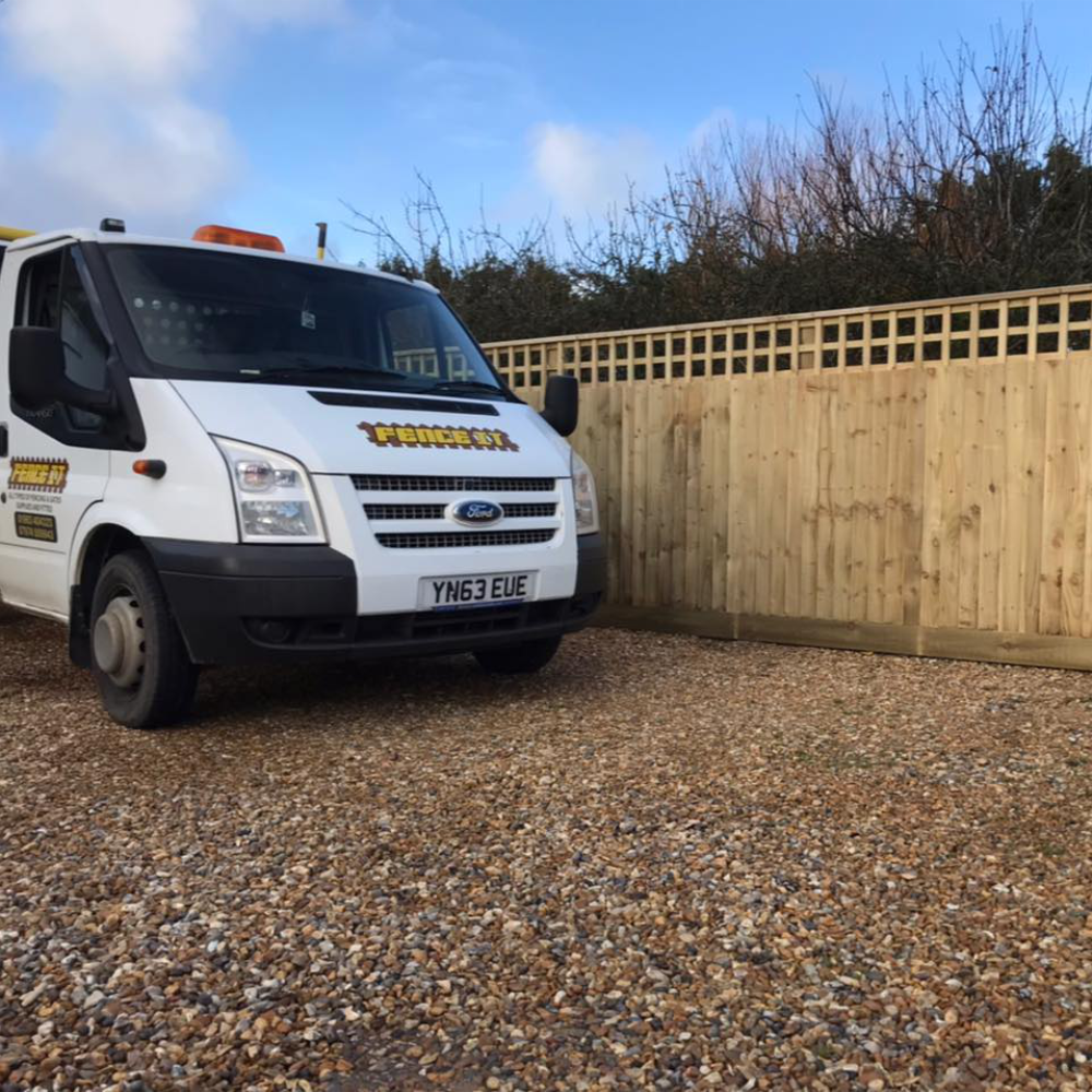 A white van parked on a gravel driveway